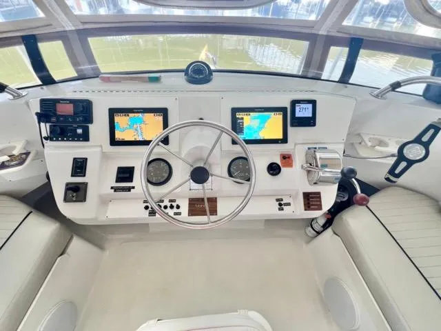 Slide: The Image of 2002 Mainship 390 Trawler helm with navigation screens and controls. - 12