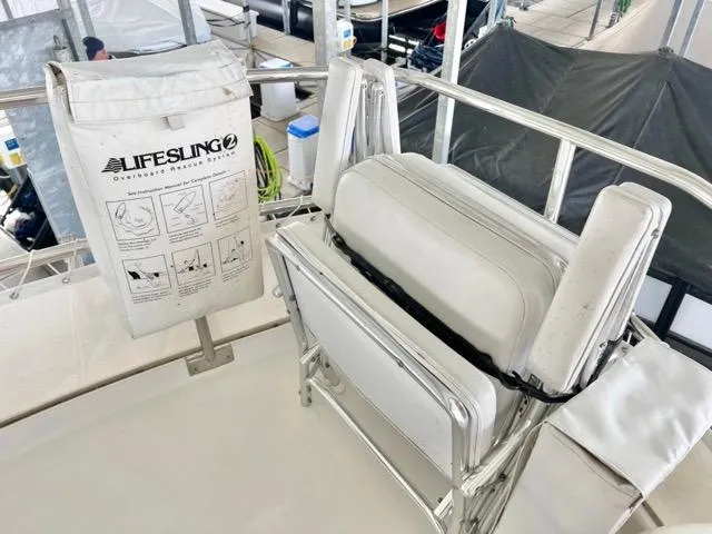 Slide: The Image of 2002 Mainship 390 Trawler deck with Lifesling safety equipment and cushioned seating. - 15