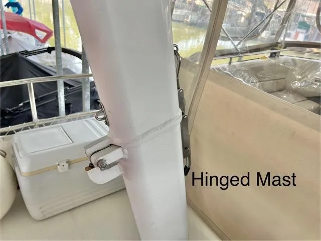 Slide: The Image of Hinged mast on 2002 Mainship 390 Trawler, featuring secure locking mechanism. - 16