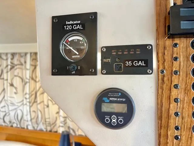 Slide: The Image of Control panel of a 2002 Mainship 390 Trawler showing fuel and waste indicators. - 22