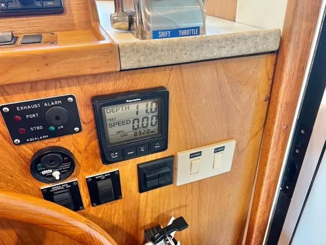 Slide: The Image of Control panel of a 2002 Mainship 390 Trawler with depth and speed indicators. - 29