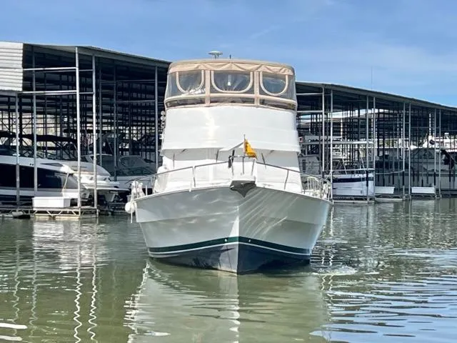 Slide: The Image of 2002 Mainship 390 Trawler docked at marina, front view. - 3