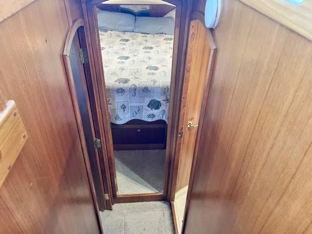 Slide: The Image of 2002 Mainship 390 Trawler interior with wooden walls and cozy bedroom view. - 31