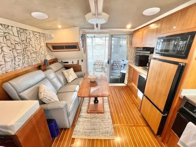 Slide: The Image of Interior of 2002 Mainship 390 Trawler with modern kitchen and cozy seating area. - 37