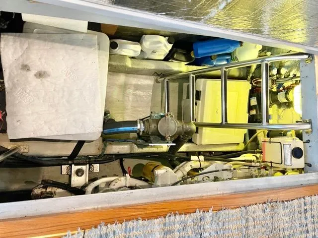 Slide: The Image of Engine room of 2002 Mainship 390 Trawler with equipment and storage items. - 39