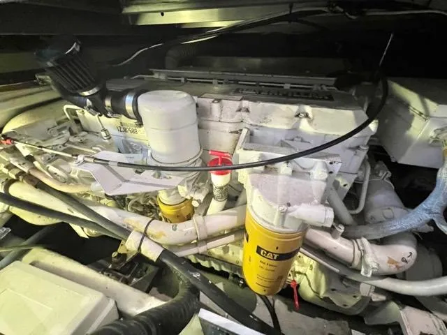 Slide: The Image of Engine compartment of a 2002 Mainship 390 Trawler with visible CAT filters. - 40