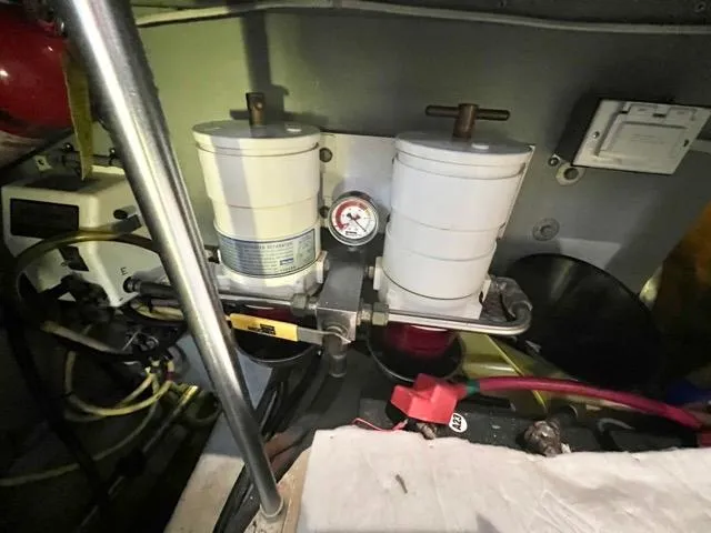 Slide: The Image of Engine room of 2002 Mainship 390 Trawler with dual fuel filters and gauge. - 42