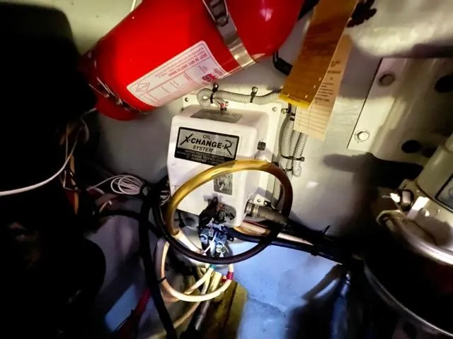 Slide: The Image of Engine room of 2002 Mainship 390 Trawler with oil change system and fire extinguisher. - 43