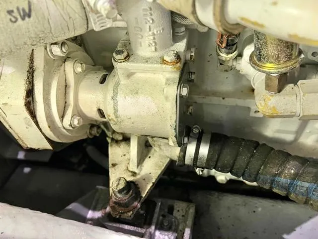 Slide: The Image of Engine component of a 2002 Mainship 390 Trawler, showing mechanical details and connections. - 45