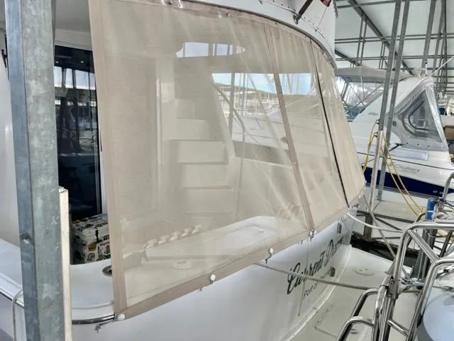 Slide: The Image of 2002 Mainship 390 Trawler with covered deck, docked in a marina. - 8