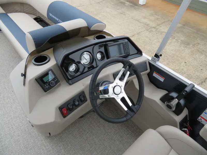 Slide: The Image of 2025 Bennington 22SSB boat dashboard with steering wheel and control panel. - 10