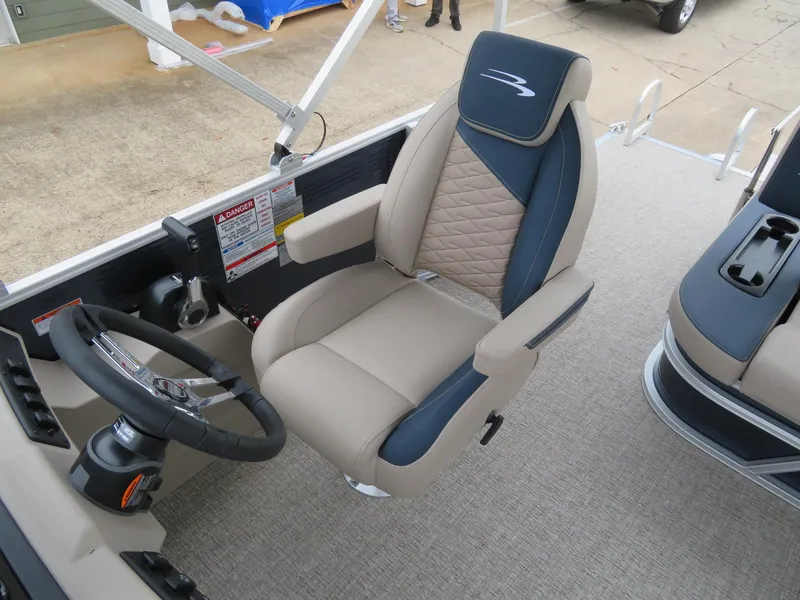Slide: The Image of Captain's chair and steering wheel of 2025 Bennington 22SSB pontoon boat. - 11