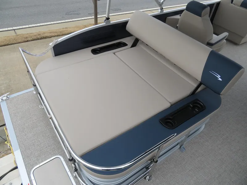 Slide: The Image of 2025 Bennington 22SSB boat interior with beige and blue seating, featuring cup holders. - 13