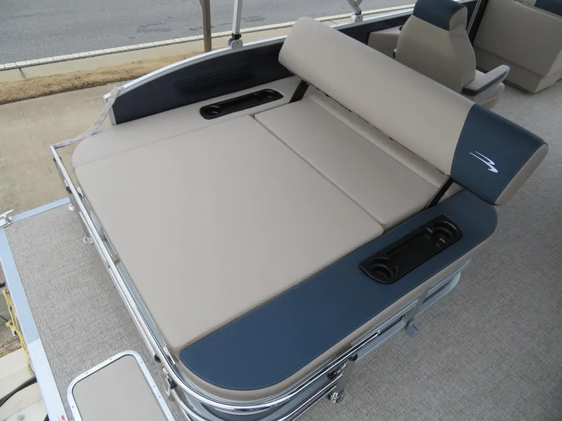 Slide: The Image of 2025 Bennington 22SSB boat interior with beige and blue seating, featuring cup holders. - 15
