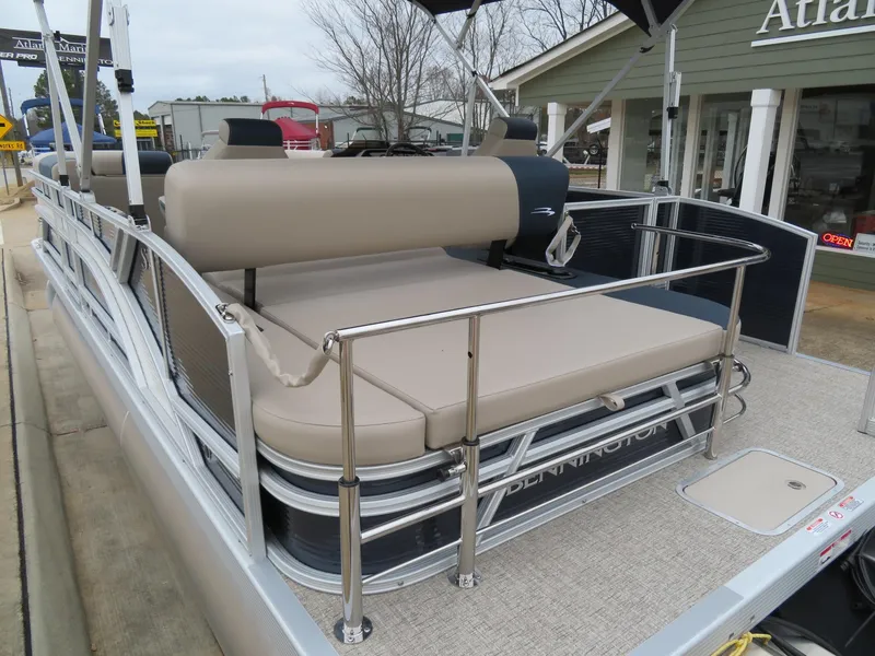 Slide: The Image of 2025 Bennington 22SSB pontoon boat with beige seating and stainless steel railings. - 7