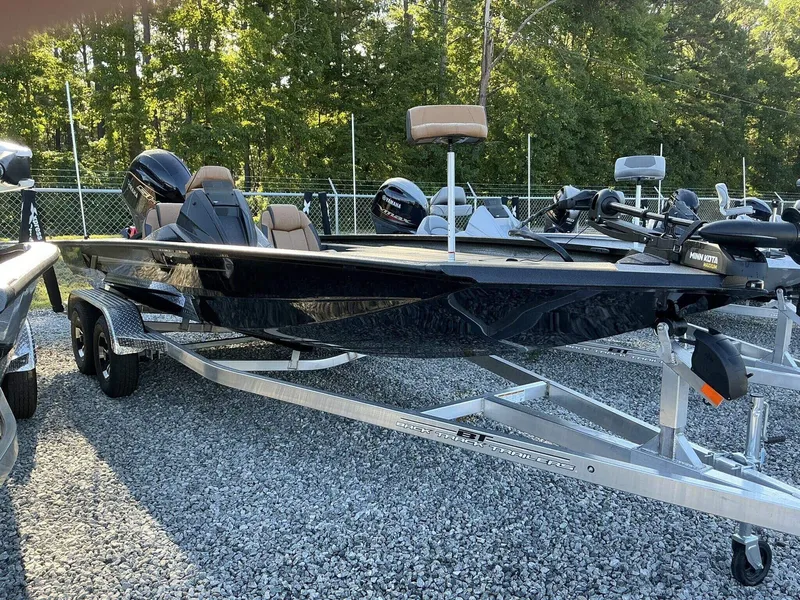 Slide: The Image of 2025 Xpress Hyper-Lift Series H20 BASS boat on trailer, parked outdoors. - 1