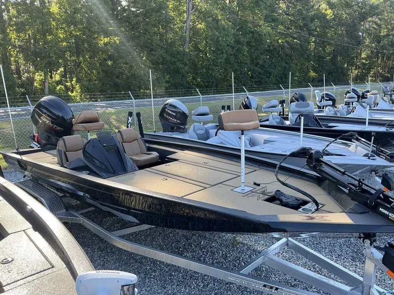 Slide: The Image of 2025 Xpress Hyper-Lift Series H20 BASS boat in a showroom, surrounded by trees. - 6