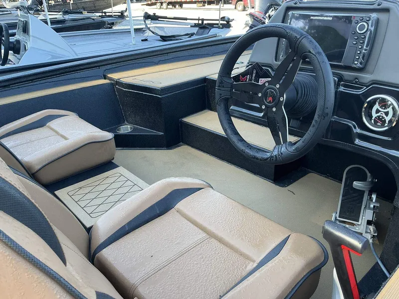 Slide: The Image of 2025 Xpress Hyper-Lift Series H20 BASS boat interior with steering wheel and seating. - 8