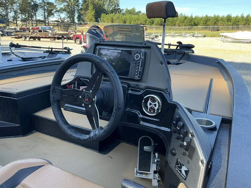 Slide: The Image of 2025 Xpress Hyper-Lift Series H20 BASS boat dashboard with steering wheel and control panel. - 9