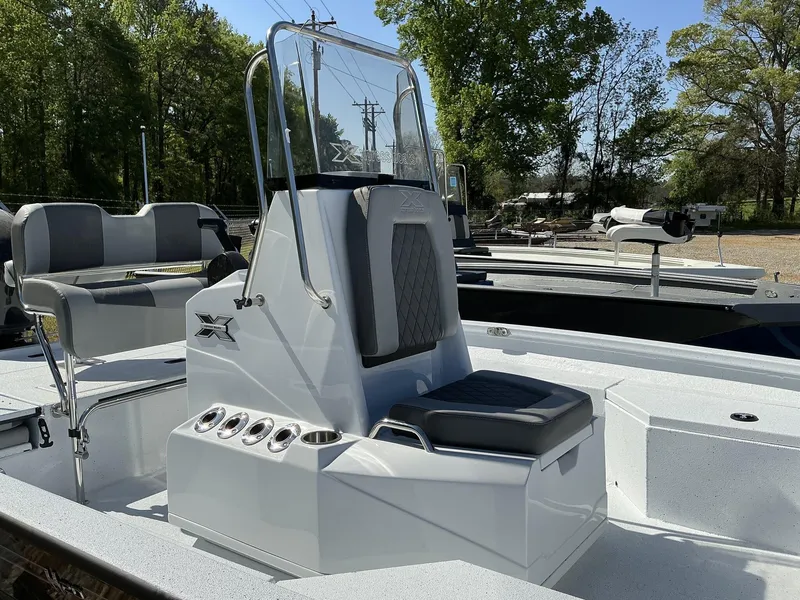 Slide: The Image of 2025 Xpress Hyper-Lift Series H20B boat console, sleek design, gray seating, outdoor setting. - 3