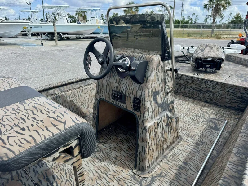 Slide: The Image of 2025 Xpress Xplorer Series XP18CC boat with camo interior and steering console. - 4