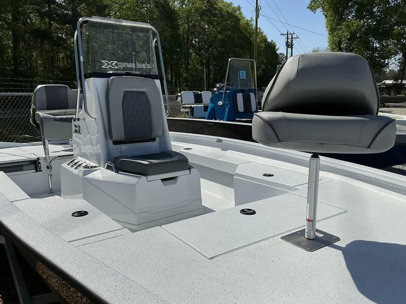 Slide: The Image of 2025 Xpress Hyper-Lift Series H20B boat with new console and seating, outdoors. - 5