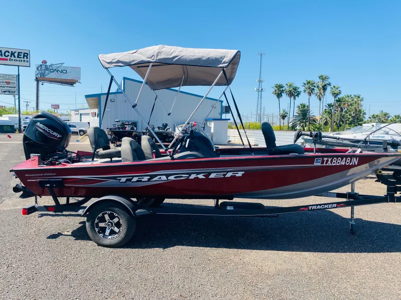 Slide: The Image of 2021 Tracker Pro Team 175 TXW Tournament Edition boat with canopy, parked outdoors. - 4