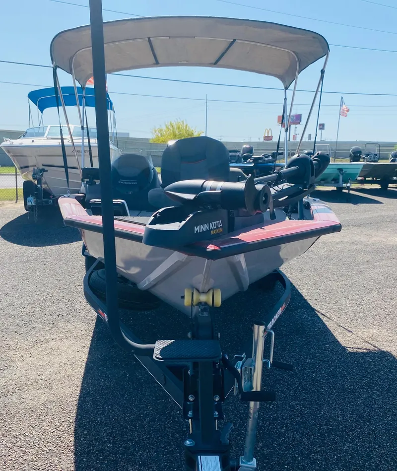 Slide: The Image of 2021 Tracker Pro Team 175 TXW Tournament Edition boat with canopy in a parking lot. - 6