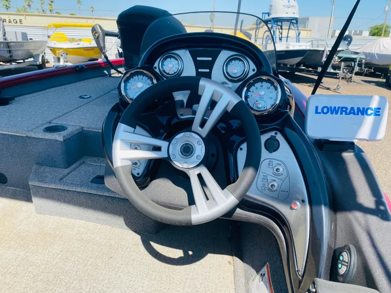 Slide: The Image of 2021 Tracker Pro Team 175 TXW Tournament Edition boat dashboard with steering wheel and gauges. - 8