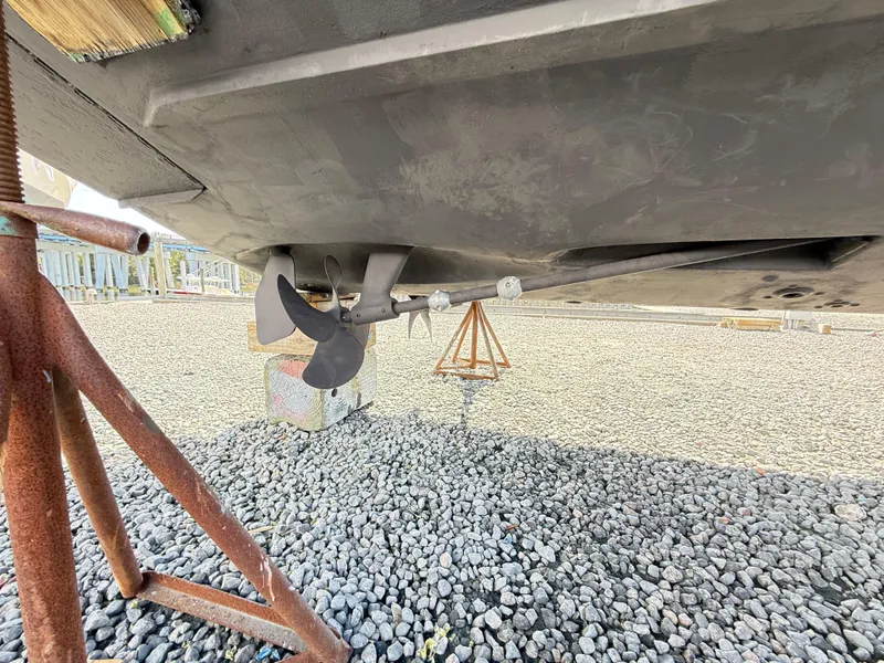 Slide: The Image of 2001 Albemarle 280 Express Sport Fisherman boat propeller on dry dock, gravel surface. - 43