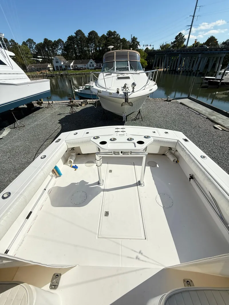 Slide: The Image of 2001 Albemarle 280 Express Sport Fisherman boat docked, showcasing spacious deck and fishing amenities. - 44