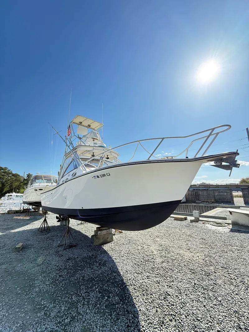 Slide: The Image of 2001 Albemarle 280 Express Sport Fisherman boat on dry dock under clear sky. - 49