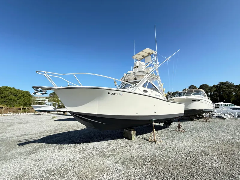Slide: The Image of 2001 Albemarle 280 Express Sport Fisherman boat on gravel lot under clear blue sky. - 50