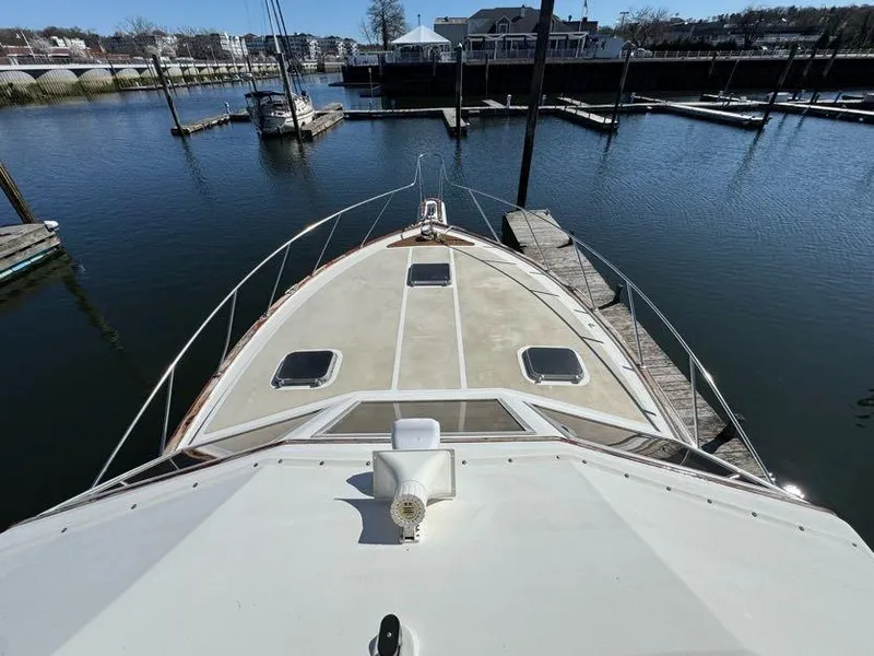 Slide: The Image of 1985 Egg Harbor 37 Convertible yacht docked at marina, view from bow. - 11