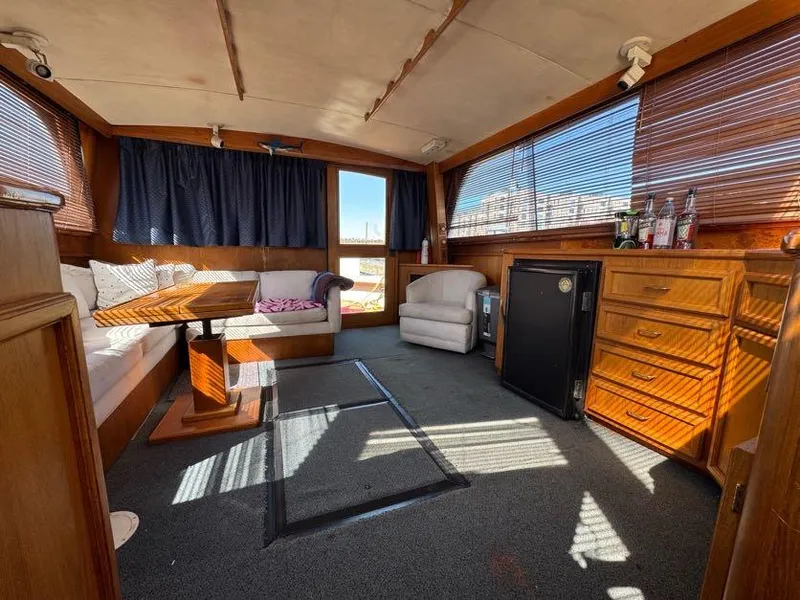 Slide: The Image of 1985 Egg Harbor 37 Convertible yacht interior with wood furnishings and seating area. - 16