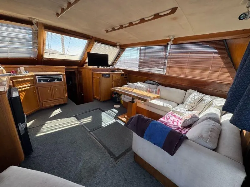 Slide: The Image of Interior of 1985 Egg Harbor 37 Convertible yacht with cozy seating and wooden accents. - 18