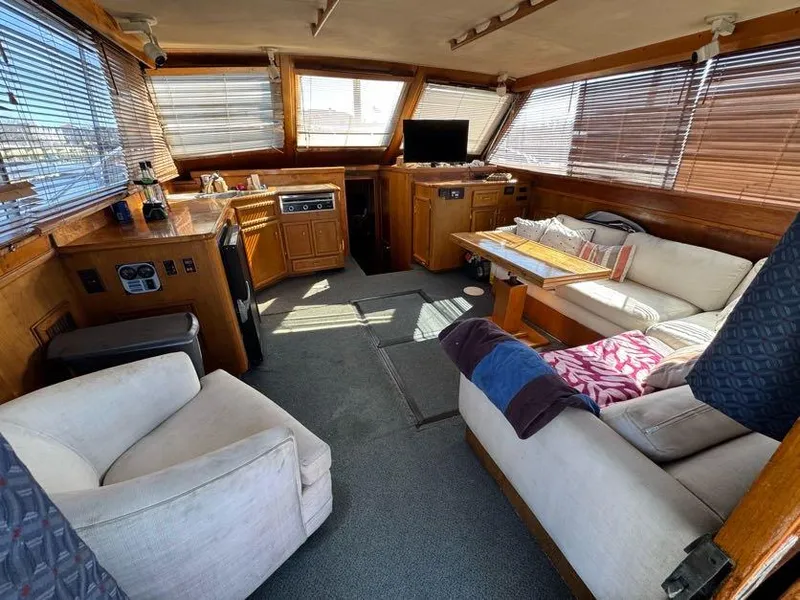 Slide: The Image of Interior of 1985 Egg Harbor 37 Convertible yacht with cozy seating and wooden accents. - 19