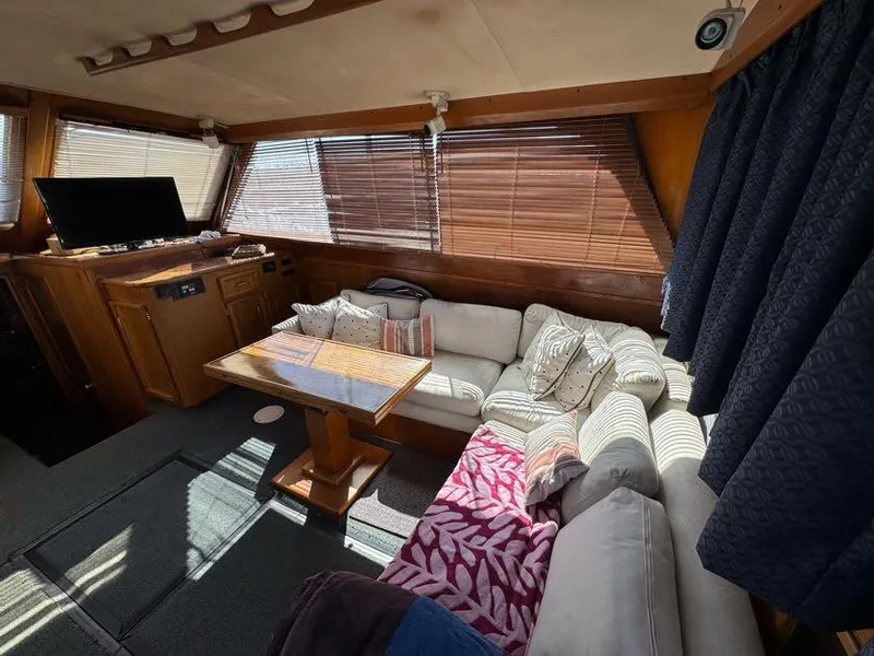 Slide: The Image of Interior of 1985 Egg Harbor 37 Convertible yacht with cozy seating and wooden accents. - 20