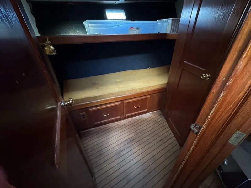 Slide: The Image of 1985 Egg Harbor 37 Convertible cabin interior with wooden cabinetry and storage space. - 22