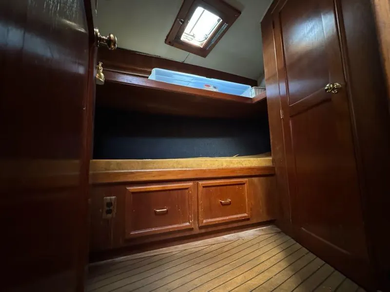 Slide: The Image of 1985 Egg Harbor 37 Convertible cabin interior with wooden storage and skylight. - 23