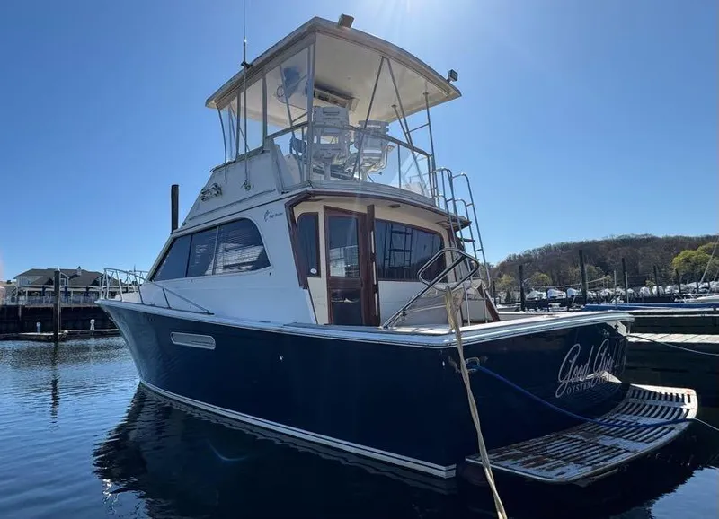Slide: The Image of 1985 Egg Harbor 37 Convertible boat docked in marina, side view. - 6
