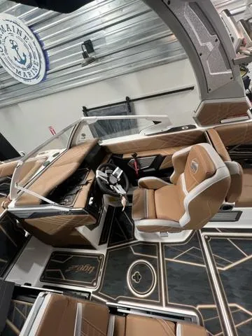Slide: The Image of 2025 Tigé 25ZX boat interior with luxurious brown seating and modern dashboard. - 6