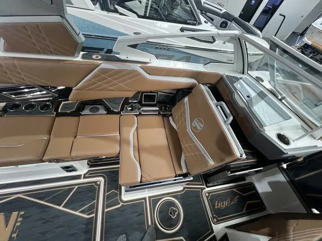 Slide: The Image of 2025 Tigé 25ZX boat interior with luxurious tan seating and modern design. - 7