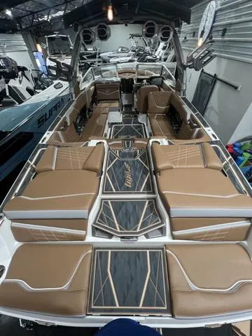 Slide: The Image of 2025 Tigé 25ZX boat interior with luxurious brown seating and modern design. - 8