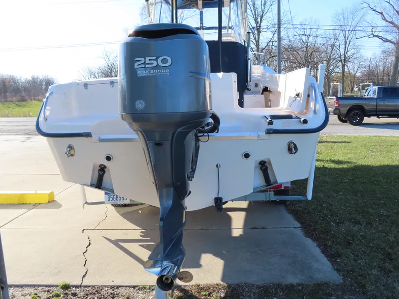 Slide: The Image of 2006 Grady-White Journey 258 boat with a 250 horsepower outboard motor, parked on pavement. - 4