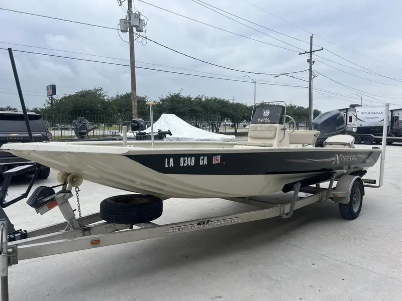 Slide: The Image of 2013 Xpress XP20 CC boat on trailer, parked outdoors under cloudy sky. - 3