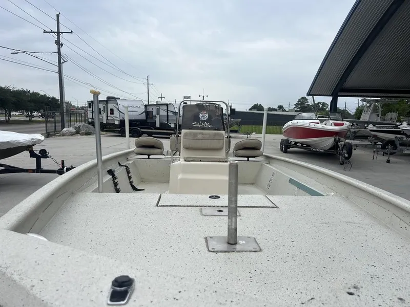 Slide: The Image of 2013 Xpress XP20 CC boat in a parking lot with other boats and trailers. - 8