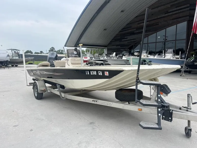 Slide: The Image of 2013 Xpress XP20 CC boat on trailer, parked outside a modern building. - 9
