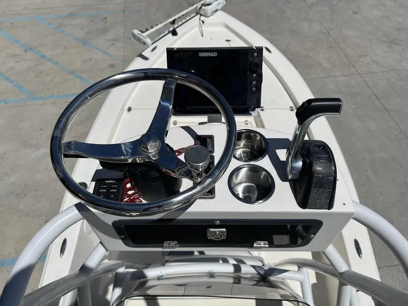 Slide: The Image of Control panel of a 2016 Avenger AV 26 boat with steering wheel and controls. - 10