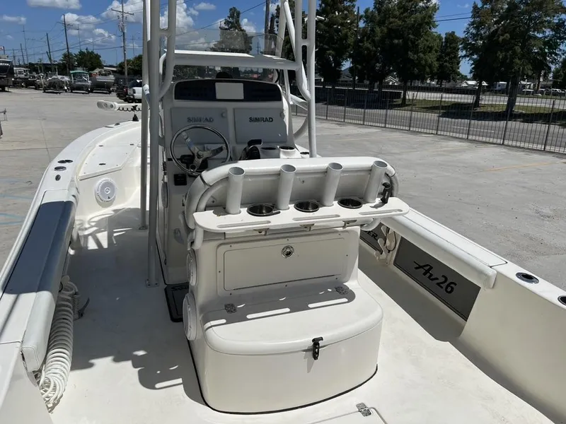 Slide: The Image of 2016 Avenger AV 26 boat interior with steering console and rod holders. - 14